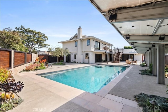 view of swimming pool featuring a patio, stairway, a fenced backyard, and a fenced in pool