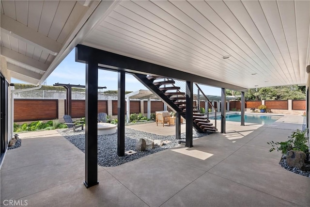 view of patio featuring stairs, a fenced backyard, and a fenced in pool