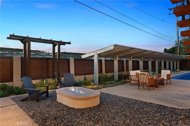 view of patio with a fire pit and fence