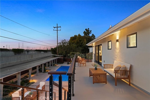 2885 Europa Dr, Costa Mesa, CA 92626 - pool at dusk with a patio area, an outdoor living space, and a fenced in pool