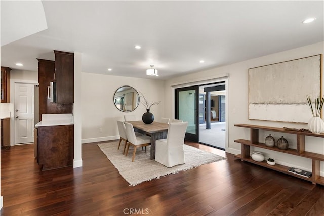 dining room with baseboards, dark wood-style flooring, and recessed lighting