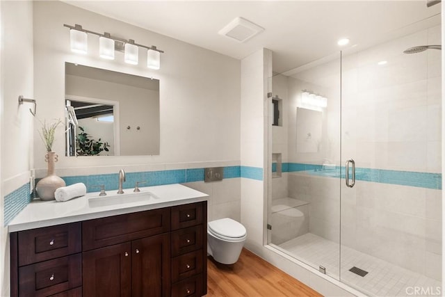 2885 Europa Dr, Costa Mesa, CA 92626 - full bath featuring a shower stall, toilet, vanity, wood finished floors, and tile walls