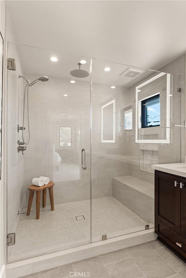 full bathroom with tile patterned flooring, a shower stall, vanity, and recessed lighting