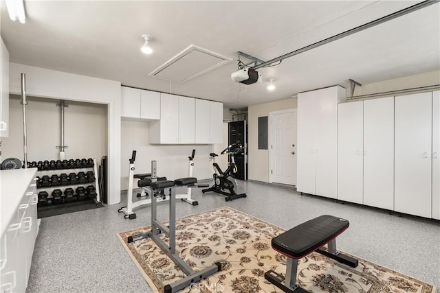 workout area featuring attic access and electric panel