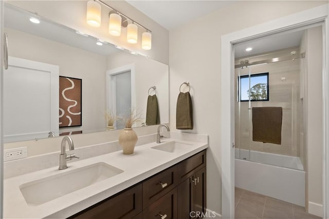 2885 Europa Dr, Costa Mesa, CA 92626 - full bath with tile patterned floors, double vanity, shower / bath combination with glass door, and a sink