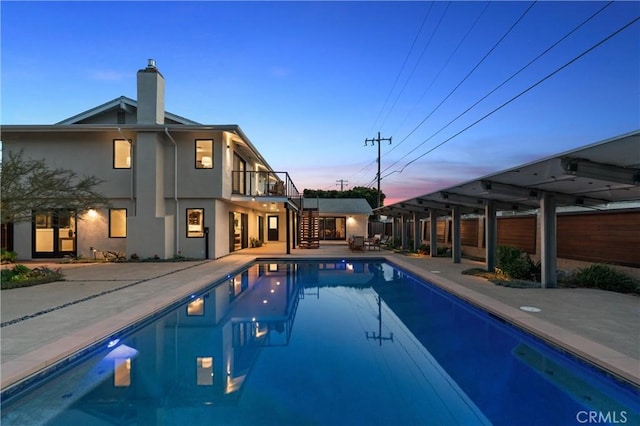 outdoor pool with a patio area and stairway