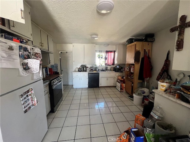 kitchen featuring light tile patterned floors, black dishwasher, freestanding refrigerator, white cabinetry, and range with electric stovetop