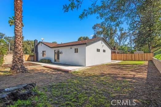 back of property with a patio, fence, and stucco siding