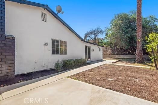 view of side of property with stucco siding