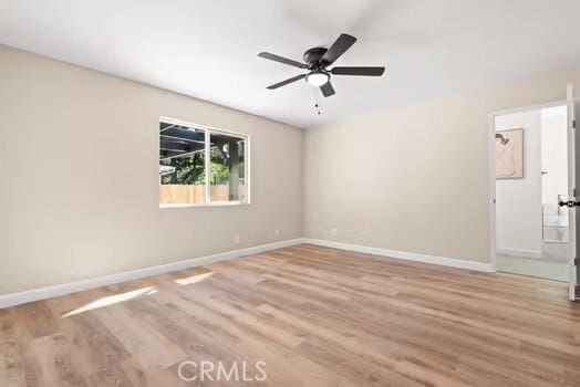 unfurnished room with ceiling fan, baseboards, and wood finished floors