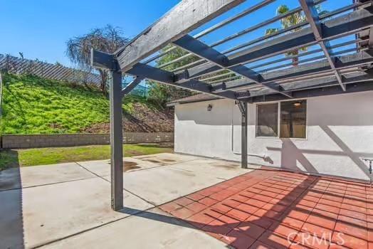 view of patio featuring fence and a pergola