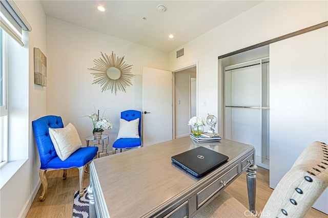 home office featuring light wood-type flooring, visible vents, baseboards, and recessed lighting