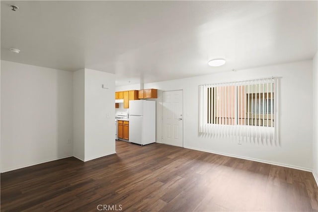 unfurnished living room with dark wood-style floors and baseboards