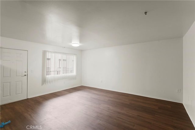 unfurnished room featuring dark wood finished floors