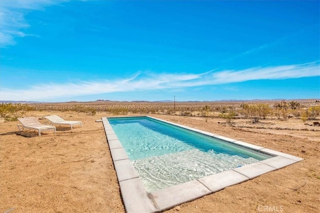 view of swimming pool with view of desert, a mountain view, and a fenced in pool