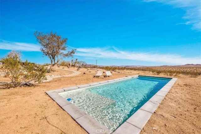 outdoor pool featuring a desert view and a mountain view