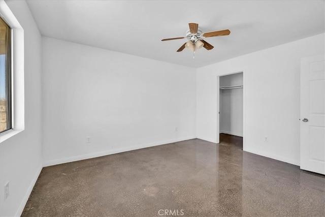 unfurnished bedroom with ceiling fan and baseboards