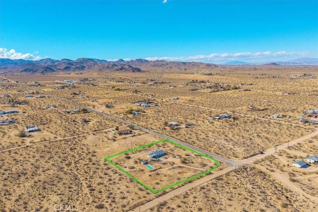 birds eye view of property featuring view of desert, a rural view, and a mountain view