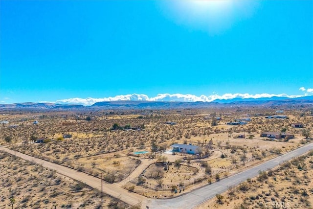 birds eye view of property with a mountain view, a desert view, and a rural view