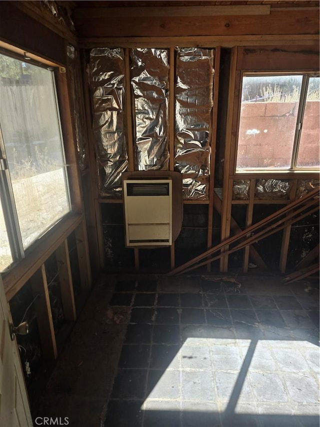 unfurnished sunroom featuring heating unit