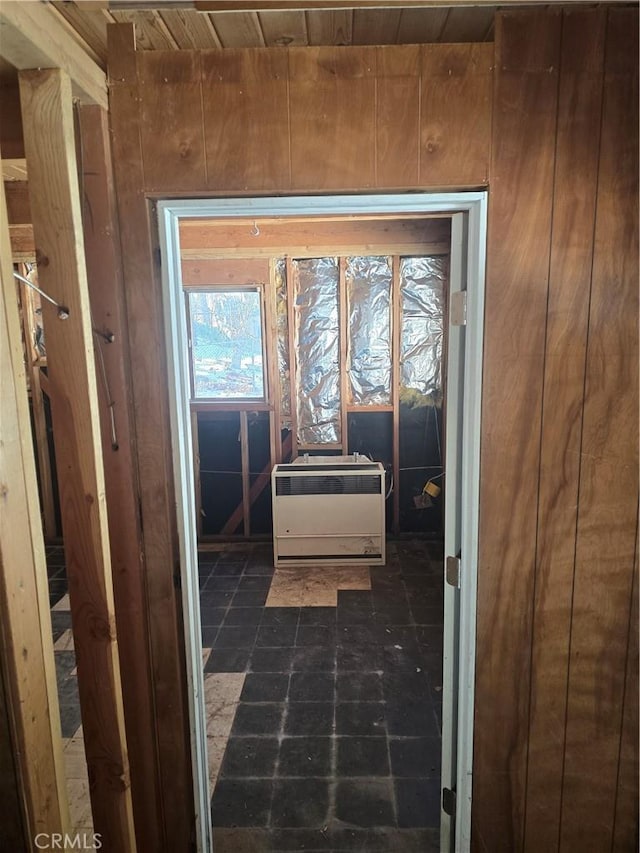 interior space with wood walls, wood ceiling, and heating unit