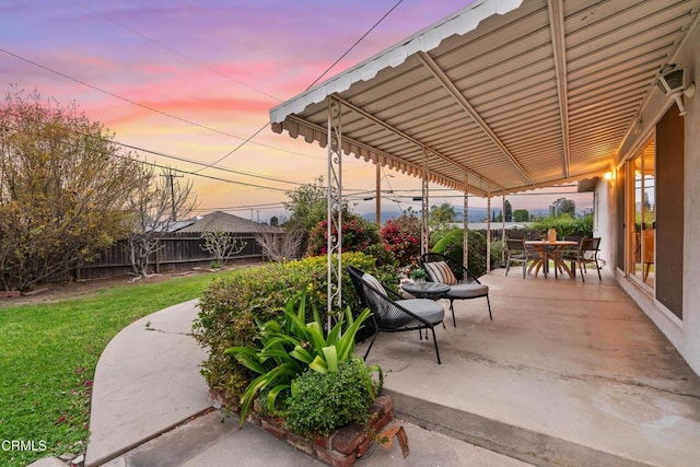 view of patio with outdoor dining space and fence