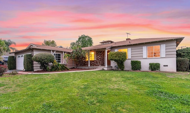 ranch-style home featuring crawl space, a lawn, and an attached garage