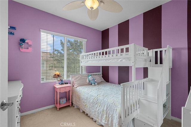 carpeted bedroom with ceiling fan and baseboards