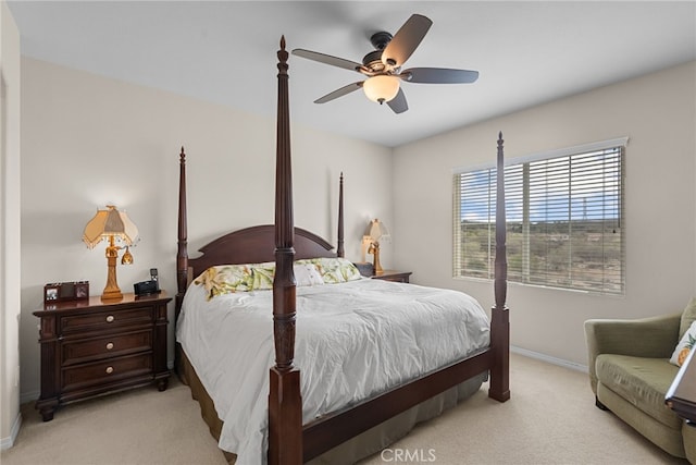 bedroom with a ceiling fan, carpet flooring, and baseboards