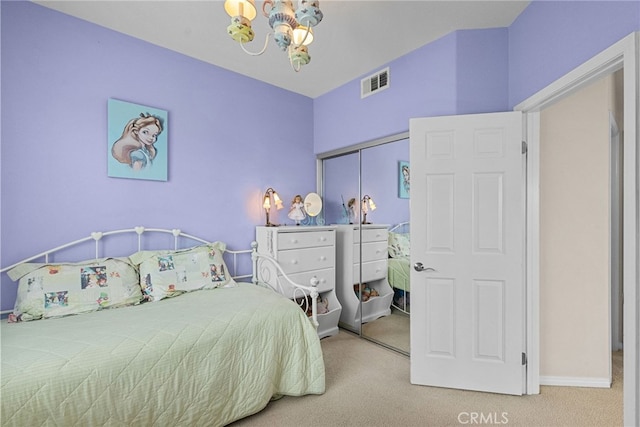 carpeted bedroom featuring baseboards, visible vents, a chandelier, and a closet