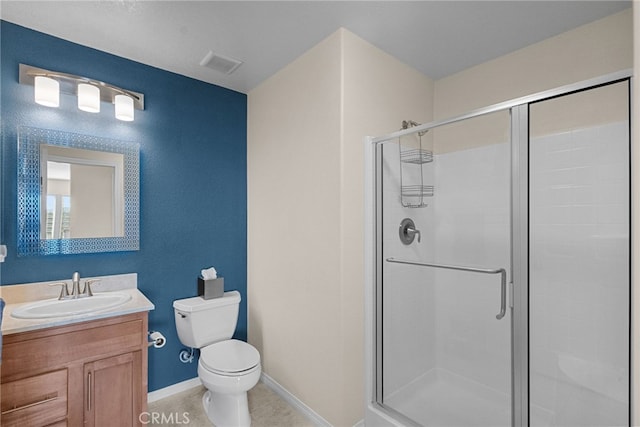 full bathroom featuring visible vents, toilet, vanity, a shower stall, and tile patterned floors