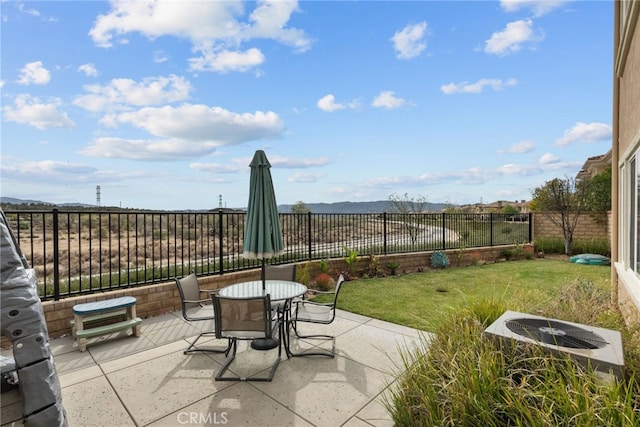 view of patio with outdoor dining area, a fenced backyard, and central air condition unit