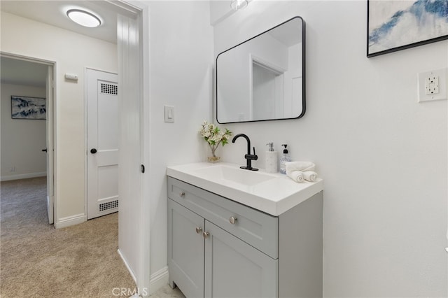 bathroom with vanity and baseboards