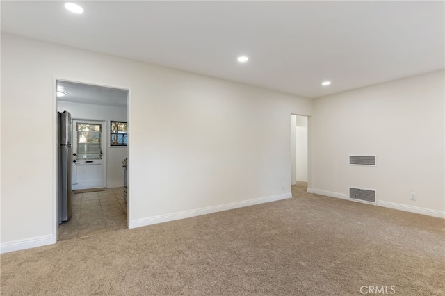 unfurnished room featuring carpet, visible vents, baseboards, and recessed lighting