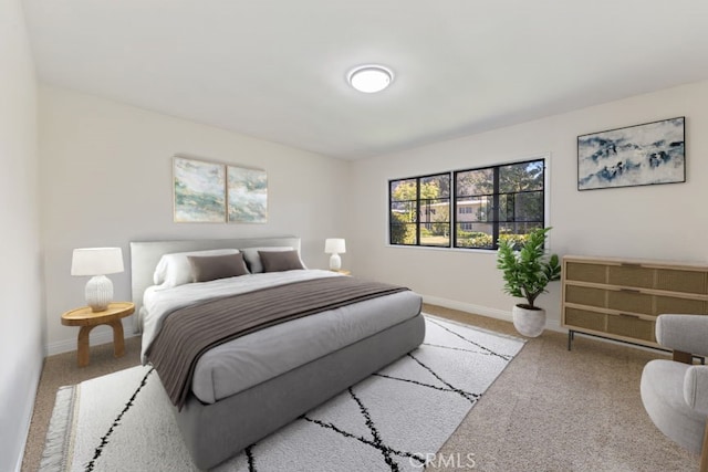 bedroom featuring carpet and baseboards