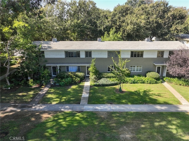 view of front of house featuring a front lawn and stucco siding