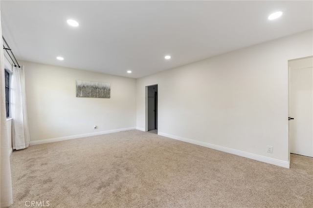 empty room featuring baseboards, carpet flooring, and recessed lighting