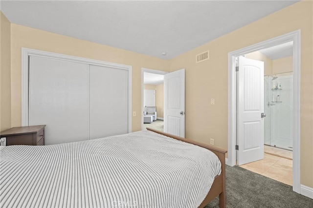 bedroom with baseboards, carpet, visible vents, and a closet