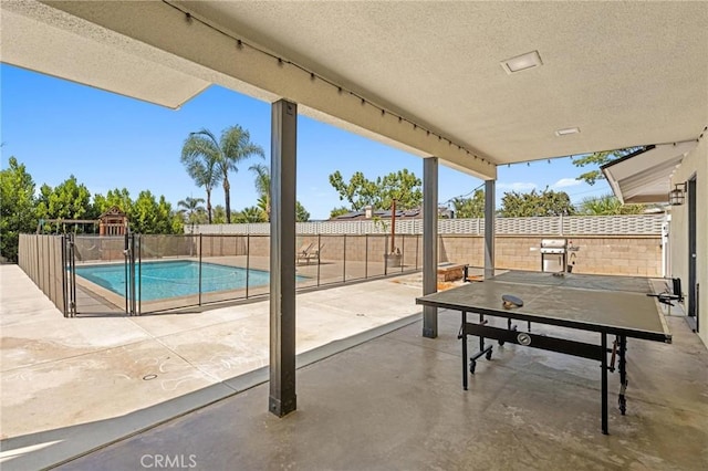 view of patio / terrace with outdoor dining space, a fenced backyard, a fenced in pool, and a grill