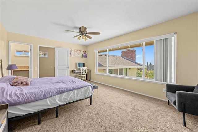 carpeted bedroom featuring a ceiling fan and baseboards