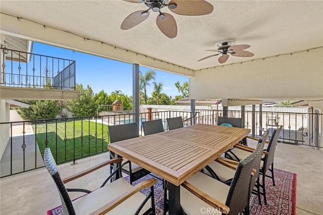 view of patio featuring ceiling fan, fence, and outdoor dining area