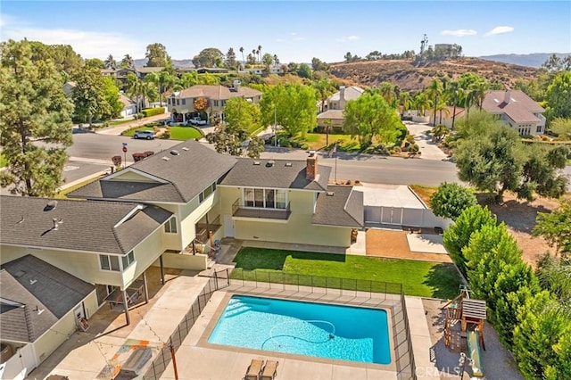 view of pool with a fenced in pool, a yard, a patio area, fence, and a residential view