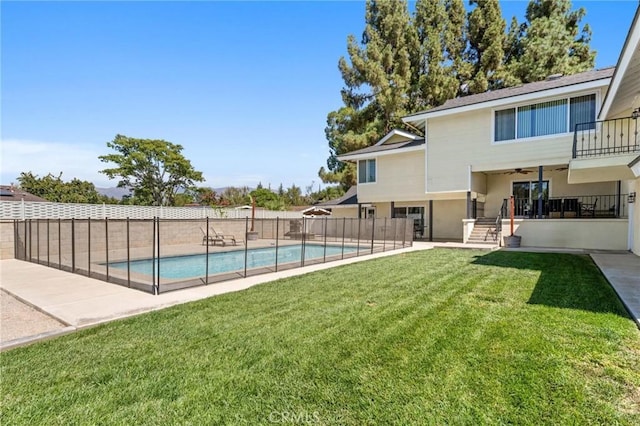 view of swimming pool with a patio, fence, a fenced in pool, and a yard