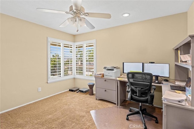 home office with baseboards, a ceiling fan, and carpet flooring