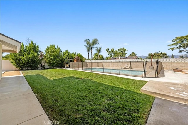 view of yard with a patio area, a fenced backyard, and a fenced in pool