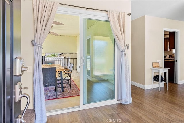 entryway with wood finished floors, a wealth of natural light, and baseboards