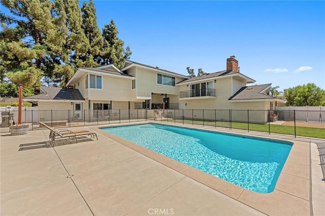 view of swimming pool with a patio area, fence, and a fenced in pool