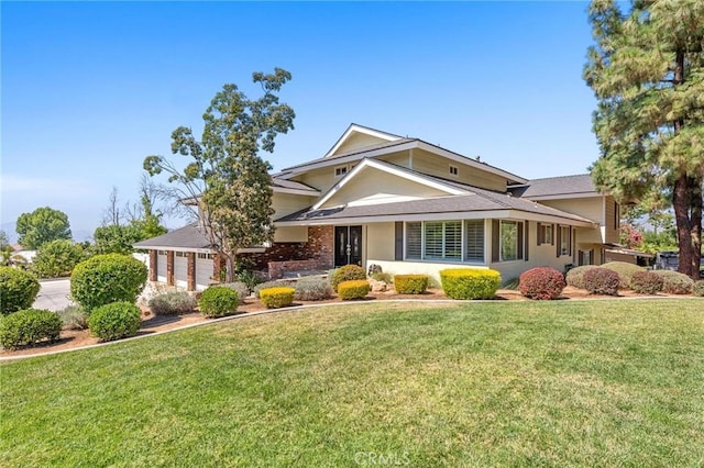 view of front facade featuring an attached garage, driveway, and a front lawn