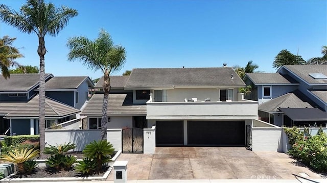 view of front of house with a fenced front yard, stucco siding, concrete driveway, a gate, and a garage