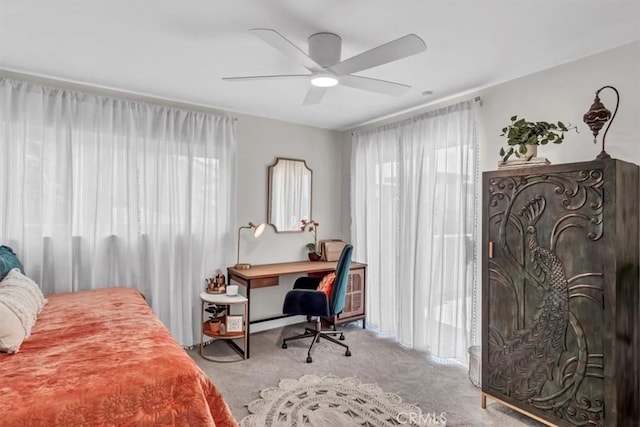 bedroom featuring carpet floors, multiple windows, and ceiling fan